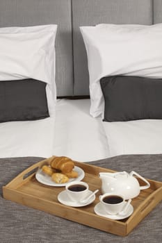 Tray with coffee on a bed in a hotel room