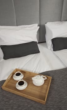Tray with coffee on a bed in a hotel room