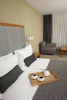 Tray with coffee on a bed in a hotel room