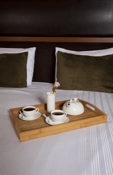 Tray with coffee on a bed in a hotel room