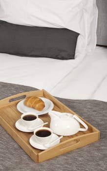 Tray with coffee on a bed in a hotel room