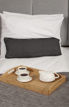 Tray with coffee on a bed in a hotel room