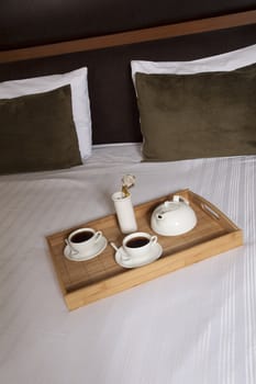 Tray with coffee on a bed in a hotel room