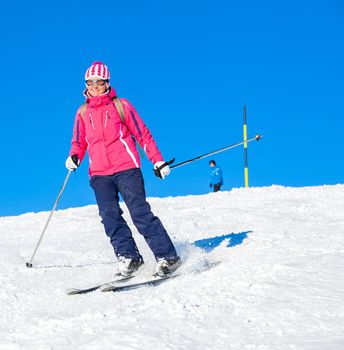 Young woman skiing on mountains in the Zillertal Arena, Austria