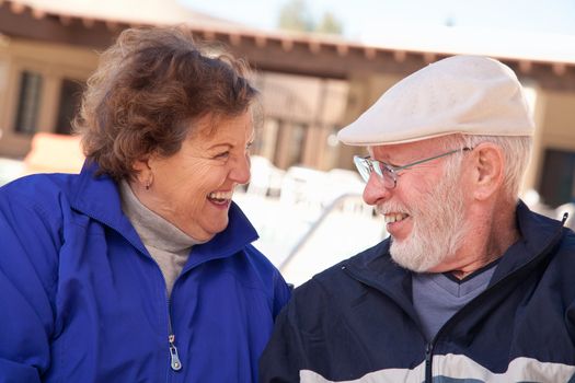 Happy Senior Adult Couple Portrait Bundled Up Outdoors.