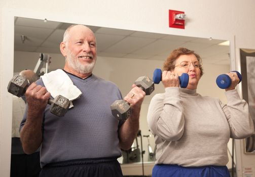Active Senior Adult Couple Working Out in the Gym.
