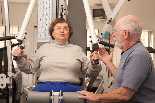 Active Senior Adult Couple Working Out Together in the Gym.