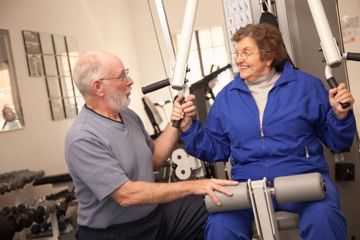 Active Senior Adult Couple Working Out Together in the Gym.