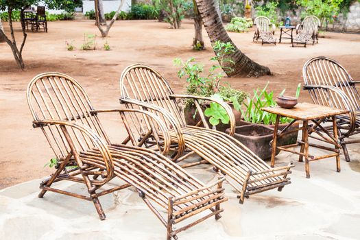 Kenya. Elegant furniture made of wood in an African garden