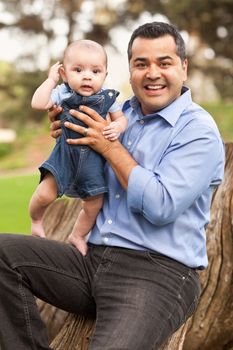 Handsome Hispanic Father and Son Posing for A Portrait in the Park.