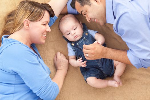 Mixed Race Family Playing Face Up on the Blanket.