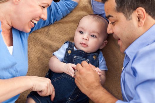 Mixed Race Family Playing Face Up on the Blanket.