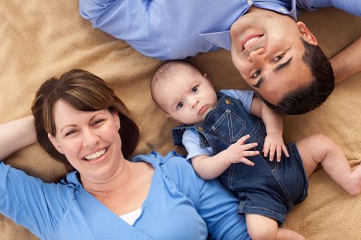 Mixed Race Family Playing Face Up on the Blanket.