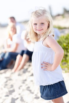 Adorable Little Blonde Girl Having Fun At the Beach with Her Family.