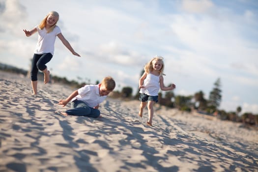 Adorable Brother and Sisters Having Fun at the Beach one Afternoon.