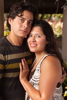 Attractive Hispanic Couple Portrait Enjoying Each Other Outdoors.