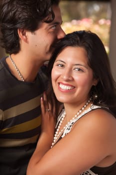 Attractive Hispanic Couple Portrait Enjoying Each Other Outdoors.