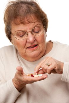 Attractive Senior Woman and Medication Pills Isolated on a White Background.