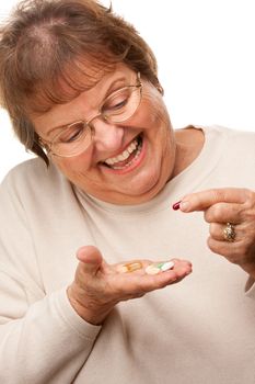Attractive Senior Woman and Medication Pills Isolated on a White Background.
