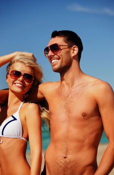 picture of happy couple in sunglasses on the beach.