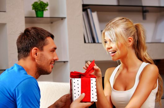bright picture of happy romantic couple with gift (focus on woman)