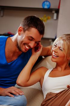 bright picture of happy couple with cellphone (focus on woman)