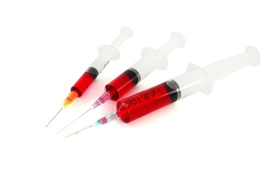 Three syringe against white background