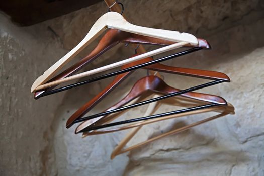 Set of empty coat hangers in a wardrobe set in an alcove of a limestone cave. Shot location was Goreme, Cappadocia, Turkey