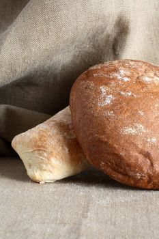 Rye and wheat bread on canvas background