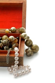 Pearl, Precious Gem and Gold Necklace in Open Wood Jewelry Casket closeup on white background