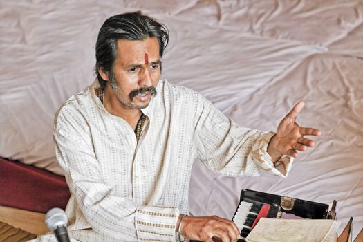 Manoj Desai, Bombay musician, singer and harmonium player rehearsing before a performance at a private venue in Bombay, April 2012