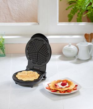 Waffle maker machine in the kitchen 