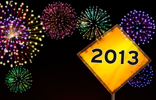 Happy New Year fireworks background with 2013 year in yellow road sign ahead.