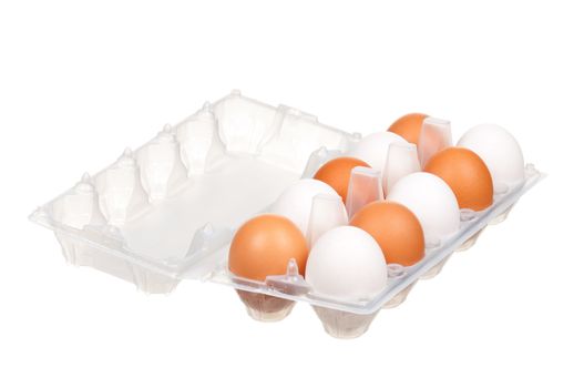 Brown and white eggs in the plastic box over white background