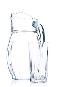 Empty pitcher for juice or milk and glass on white background