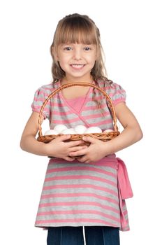 Happy little girl holding basket of eggs over white background