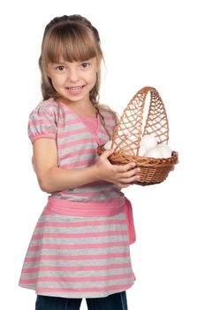 Happy little girl holding basket of eggs over white background