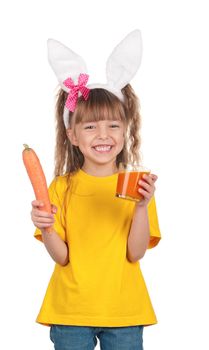 Portrait of happy little girl with carrot juice over white background