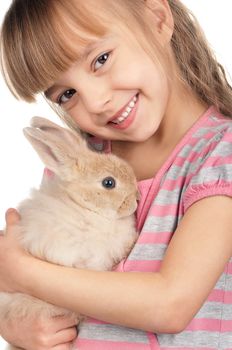 Easter concept image. Portrait of happy little girl with adorable rabbit over white background.