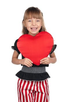 Portrait of little girl holding red heart over white background