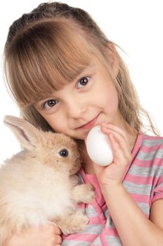 Easter concept image. Portrait of happy little girl with adorable rabbit and egg over white background.