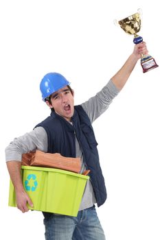 Builder with a trophy recycling material
