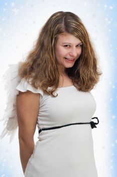 innocence christmas angel with golden hair and wings on white blue background with stars and snow looking shy