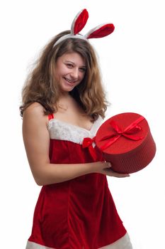 young christmas woman in red santa claus dress is holding a christmas present 