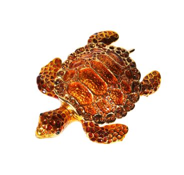 Metal tortoise with crystals on the white background (souvenir)
