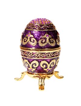 Metal egg with crystals on the white background (souvenir)
