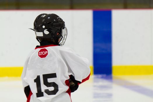 Little boy playing ice hockey