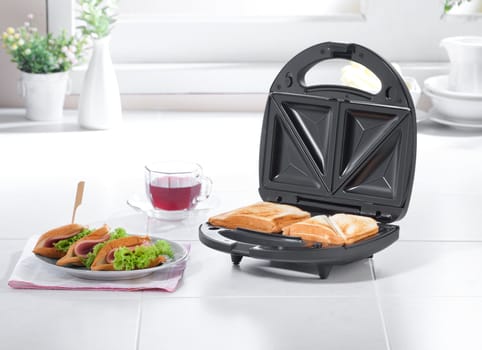 Sandwich maker machine in the kitchen 