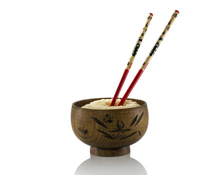 wooden cup of rice with chopsticks isolated on white