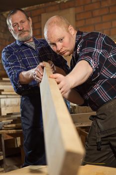 master transmits their skills in woodworking apprentice
